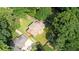 Aerial view of a home with a large lot surrounded by lush greenery and nearby homes at 1177 Castle Way Way, Norcross, GA 30093