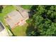 Aerial view of the back of a home featuring a spacious lawn and lush tree coverage at 1177 Castle Way Way, Norcross, GA 30093