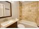 Bathroom featuring a tiled shower and tub, toilet, sink, vanity, and a framed mirror at 1177 Castle Way Way, Norcross, GA 30093
