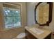 Bathroom with a new sink and granite countertop complemented by a beautiful framed mirror at 1177 Castle Way Way, Norcross, GA 30093