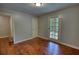 Bright bedroom with hardwood floors, neutral walls, and French door access at 1177 Castle Way Way, Norcross, GA 30093