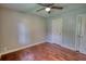 Bedroom showcasing hardwood floors, ceiling fan, window with natural light, and a closet at 1177 Castle Way Way, Norcross, GA 30093