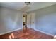 An empty bedroom with hardwood floors, neutral walls, a closet, and a window with natural light at 1177 Castle Way Way, Norcross, GA 30093