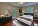 Bedroom featuring a bed, dresser, and access to the outside from the glass paneled door at 1177 Castle Way Way, Norcross, GA 30093