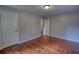 Bedroom with hardwood flooring, two doors and neutral walls, perfect for relaxation at 1177 Castle Way Way, Norcross, GA 30093