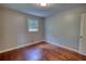 Hardwood floor bedroom, features a window and a doorway for natural light at 1177 Castle Way Way, Norcross, GA 30093