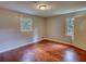 A charming bedroom with hardwood flooring and natural light from two windows at 1177 Castle Way Way, Norcross, GA 30093
