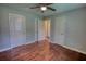 A bedroom featuring hardwood floors, a ceiling fan, closet doors, and freshly painted walls at 1177 Castle Way Way, Norcross, GA 30093