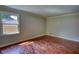 Bedroom featuring hardwood floors, neutral walls, and a window view of the outdoors at 1177 Castle Way Way, Norcross, GA 30093