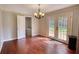 Dining room with wood floors and views into a laundry room and French doors to the back yard at 1177 Castle Way Way, Norcross, GA 30093