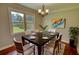 Inviting dining area with a modern table set, hardwood floors, and natural light from the large window at 1177 Castle Way Way, Norcross, GA 30093