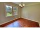 Bright dining room featuring hardwood floors, crown molding, chandelier, and large window with view of the outdoors at 1177 Castle Way Way, Norcross, GA 30093
