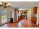 Bright kitchen with stainless steel appliances, wood cabinets, granite counters, and hardwood floors leading to backyard at 1177 Castle Way Way, Norcross, GA 30093