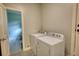 Convenient laundry room with a washer and dryer, and a view of an additional storage space at 1177 Castle Way Way, Norcross, GA 30093