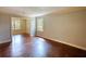 Spacious living room with hardwood floors, neutral walls, and an open doorway to the dining room at 1177 Castle Way Way, Norcross, GA 30093