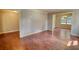 Open-concept living room with hardwood floors, neutral walls, and a view of the dining area at 1177 Castle Way Way, Norcross, GA 30093