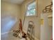 A small utility room with a water heater, window, and some tools and equipment at 1177 Castle Way Way, Norcross, GA 30093