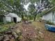 Overgrown backyard with logs, debris, and a shed at 2588 Sandtown Sw Rd, Marietta, GA 30060