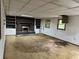 Spacious basement area with fireplace and built-in shelving, needing renovation and repair at 2588 Sandtown Sw Rd, Marietta, GA 30060