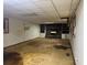 Basement view of fireplace, built in shelving and needing floor repair at 2588 Sandtown Sw Rd, Marietta, GA 30060