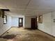 Basement view into other rooms needing repair, with holes in ceiling and floor at 2588 Sandtown Sw Rd, Marietta, GA 30060