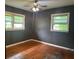 Bedroom with hardwood flooring, ceiling fan, and two windows at 2588 Sandtown Sw Rd, Marietta, GA 30060