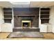 Brick fireplace with decorative wood mantle and surrounding built-in bookshelves and cabinets at 2588 Sandtown Sw Rd, Marietta, GA 30060