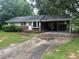 Home with a long driveway, a covered parking area and front yard at 2588 Sandtown Sw Rd, Marietta, GA 30060
