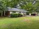 Cozy home with mature trees, a well-maintained lawn, and a welcoming front exterior at 2588 Sandtown Sw Rd, Marietta, GA 30060