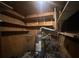 Enclosed water heater with piping, plywood walls and shelving above in a storage area at 2588 Sandtown Sw Rd, Marietta, GA 30060