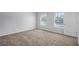 Spacious bedroom with neutral carpet, two windows, and a closet door at 3005 Nicholas Dr, Villa Rica, GA 30180