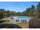 Sparkling community pool with comfortable lounge chairs for relaxation, surrounded by beautiful landscaping and mature trees at 3005 Nicholas Dr, Villa Rica, GA 30180