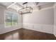 Dining room with hardwood floors, wainscoting, coffered ceiling, and a modern chandelier at 3005 Nicholas Dr, Villa Rica, GA 30180