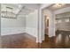 Elegant dining room with hardwood floors, decorative molding, and a modern chandelier at 3005 Nicholas Dr, Villa Rica, GA 30180