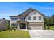 Charming two-story home with a brick-accented facade and well-manicured front lawn at 3005 Nicholas Dr, Villa Rica, GA 30180