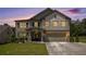 Charming two-story home with a brick-accented facade and well-manicured front lawn at dusk at 3005 Nicholas Dr, Villa Rica, GA 30180