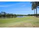 Scenic golf course view with well-manicured green grass and a serene lake, perfect for a relaxing day on the course at 3005 Nicholas Dr, Villa Rica, GA 30180