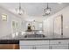 Open concept kitchen featuring a granite island, stainless steel sink, and view into the living room at 3005 Nicholas Dr, Villa Rica, GA 30180