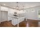 Bright kitchen with white cabinetry, stainless appliances, granite countertops, and center island at 3005 Nicholas Dr, Villa Rica, GA 30180