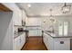 Well-lit kitchen with white cabinets, granite countertops, stainless steel appliances, and hardwood floors at 3005 Nicholas Dr, Villa Rica, GA 30180