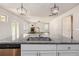 Open concept kitchen featuring a granite island, stainless steel sink, and view into the living room at 3005 Nicholas Dr, Villa Rica, GA 30180