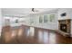 Open living area with hardwood floors, fireplace, and adjacent kitchen with white cabinets at 3005 Nicholas Dr, Villa Rica, GA 30180
