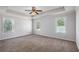 Spacious main bedroom featuring carpeted floor, ceiling fan, and natural light at 3005 Nicholas Dr, Villa Rica, GA 30180