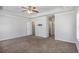Large main bedroom featuring carpeted floor, ceiling fan, and access to ensuite bathroom and walk-in closet at 3005 Nicholas Dr, Villa Rica, GA 30180