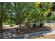 Charming playground with a slide and play structure, surrounded by lush trees in a serene community setting at 3005 Nicholas Dr, Villa Rica, GA 30180