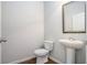 Simple powder room with pedestal sink, framed mirror and tile flooring at 3005 Nicholas Dr, Villa Rica, GA 30180