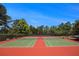 Well-maintained tennis courts ready for a friendly match, surrounded by lush greenery and beautiful trees at 3005 Nicholas Dr, Villa Rica, GA 30180