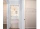 Hallway view of walk-in closet and bathroom with double vanity sinks at 3005 Nicholas Dr, Villa Rica, GA 30180