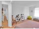 Bright bedroom with hardwood floors, a bike, and natural light streaming in from a large window at 301 Cobblestone Trl, Avondale Estates, GA 30002