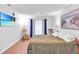 Airy bedroom featuring hardwood floors, a rocking chair, and a view from the sliding glass door at 301 Cobblestone Trl, Avondale Estates, GA 30002